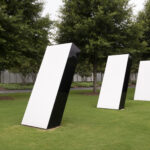 An outdoor image of three identical silver structures. They are positioned at an angle, in a single row, in front of tall trees on a grassy lawn.