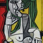 A painting of a nude, seated woman. Her face and body are made up of abstract, geometric shapes. She is sitting in a chair, with her left arm on the armrest and her right arm propped under her jaw.
