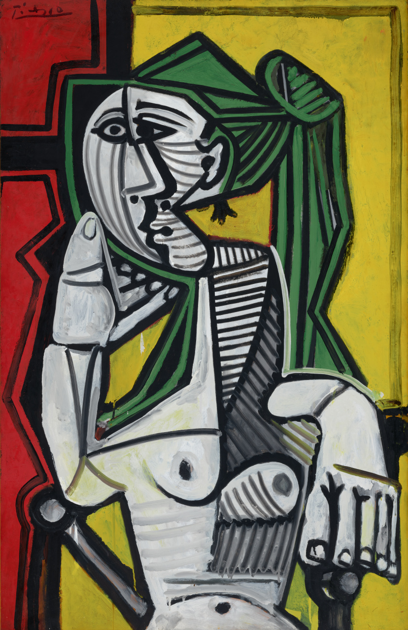 2023-03-30_PICASSO_TR_2023_5_1_POLA_PUB A painting of a nude, seated woman. Her face and body are made up of abstract, geometric shapes. She is sitting in a chair, with her left arm on the armrest and her right arm propped under her jaw.