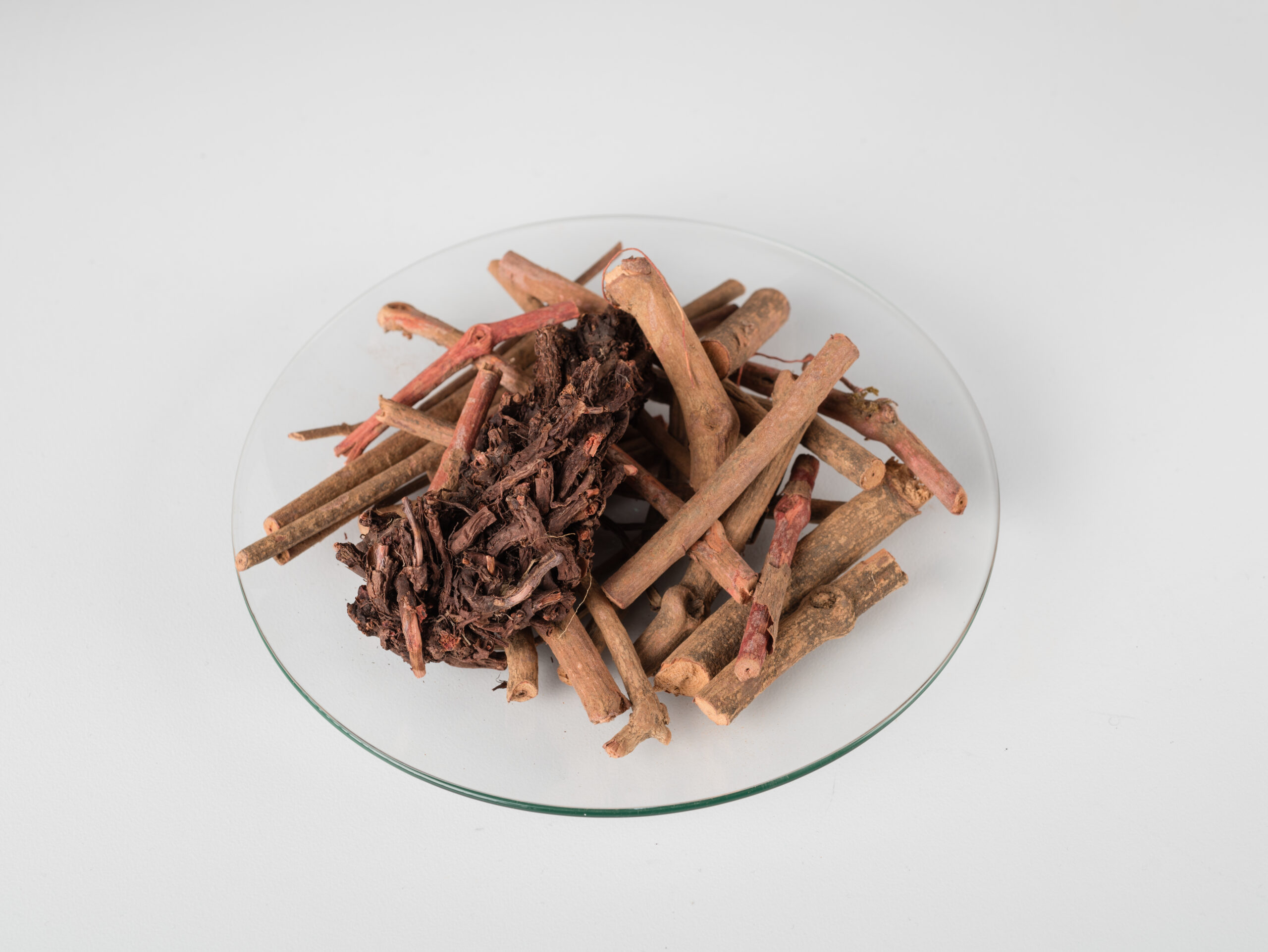 A glass bowl of madder root A glass bowl of madder root