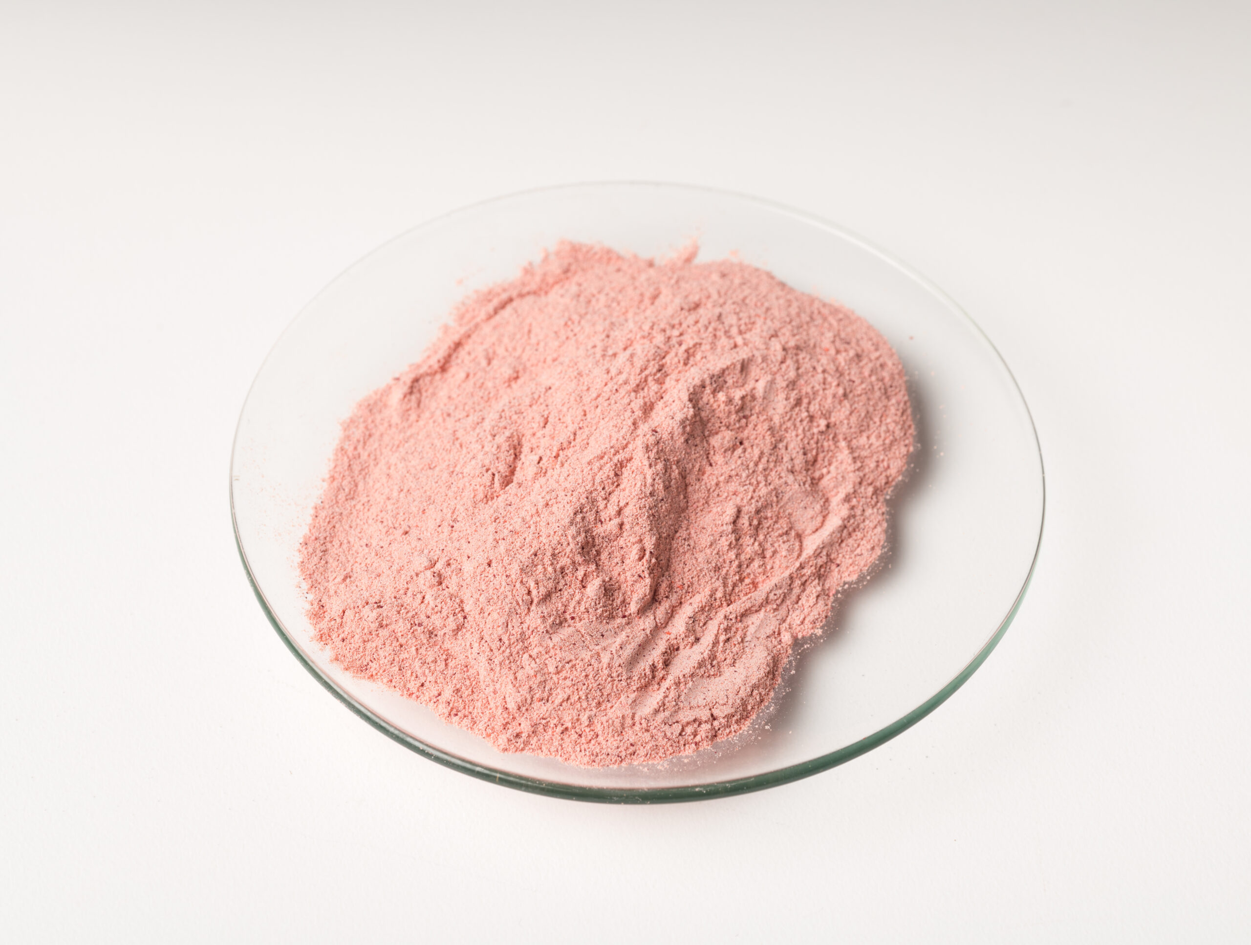 A glass bowl of rose madder powder A glass bowl of rose madder powder