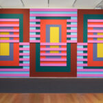 A photo of a large wall covered in brightly colored rectangular panels