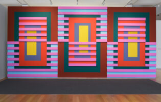 A photo of a large wall covered in brightly colored rectangular panels