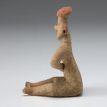 A photo of an Olmec style ceramic seated figure