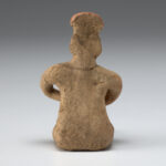 A photo of an Olmec style ceramic seated figure