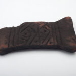 A photo of a funerary object made of camwood from the Kuba Kingdom