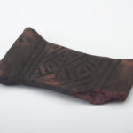 A photo of a funerary object made of camwood from the Kuba Kingdom