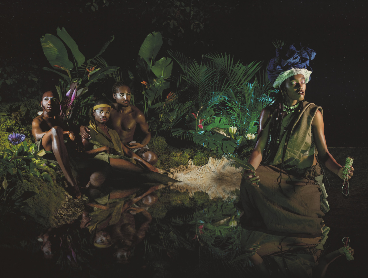 2022-03-01_UDEMEZUE_Untitled_2022_4 A color photograph of four people with dark skin tones in a nighttime jungle scene