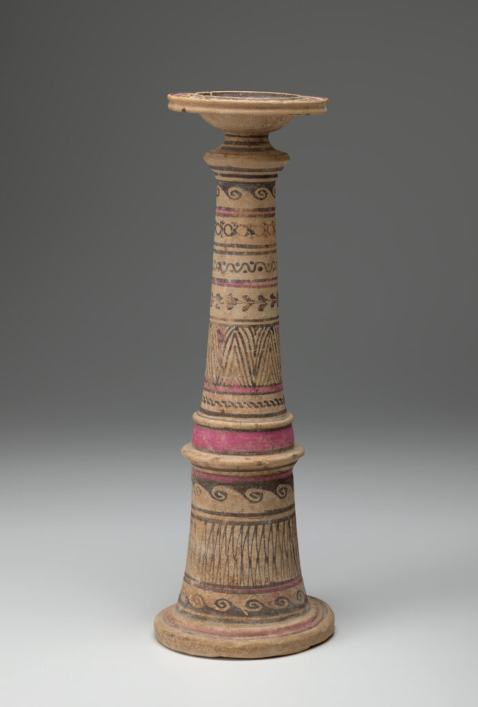 Beige ceramic cylindrical incense burner with a flared base topped with a broad-lipped bowl