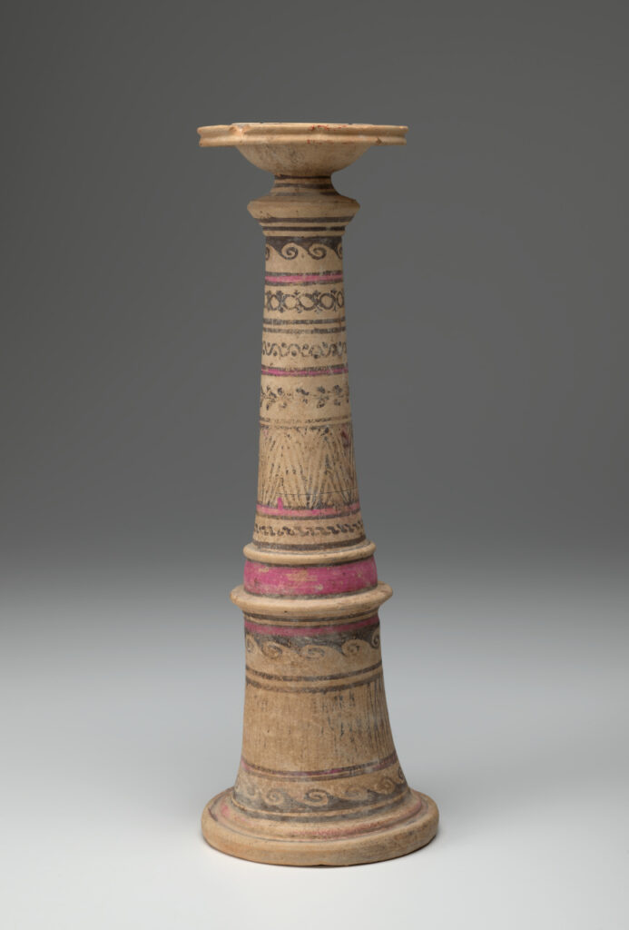 Beige ceramic cylindrical incense burner with a flared base topped with a broad-lipped bowl