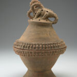 Reddish-brown ceramic incense burner bowl with a crested crocodile figure on top of the lid