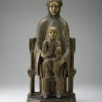 A wooden sculpture depicting the Virgin and Child sitting on a throne