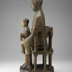 A wooden sculpture depicting the Virgin and Child sitting on a throne