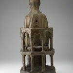 A wooden sculpture depicting the Virgin and Child sitting on a throne