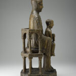 A wooden sculpture depicting the Virgin and Child sitting on a throne