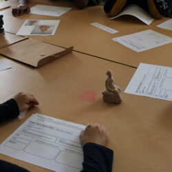 Table with worksheets and a small 3D printed object