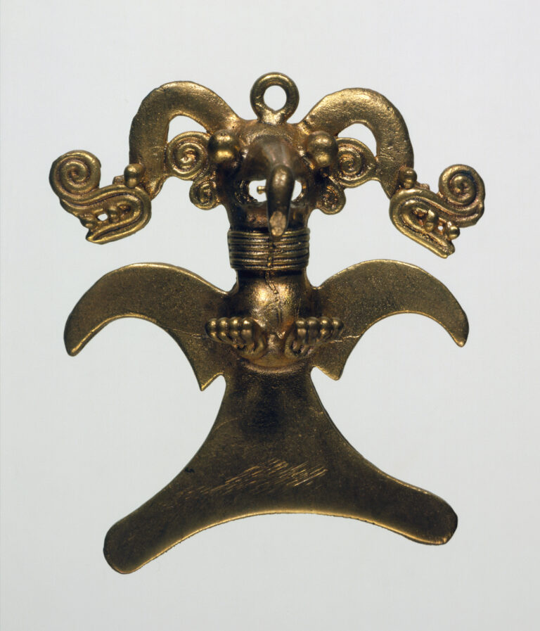 A symmetrical gold metal pendant of an eagle in flight with wings spread, wearing an ornate, two-headed snake headdress.