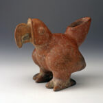 A reddish-brown ceramic vessel shaped like a parrot with the tail as the spout.