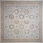 Square mosaic floor made of white marble pieces and colored glass, organized to create floral desgins and geometric patterns.